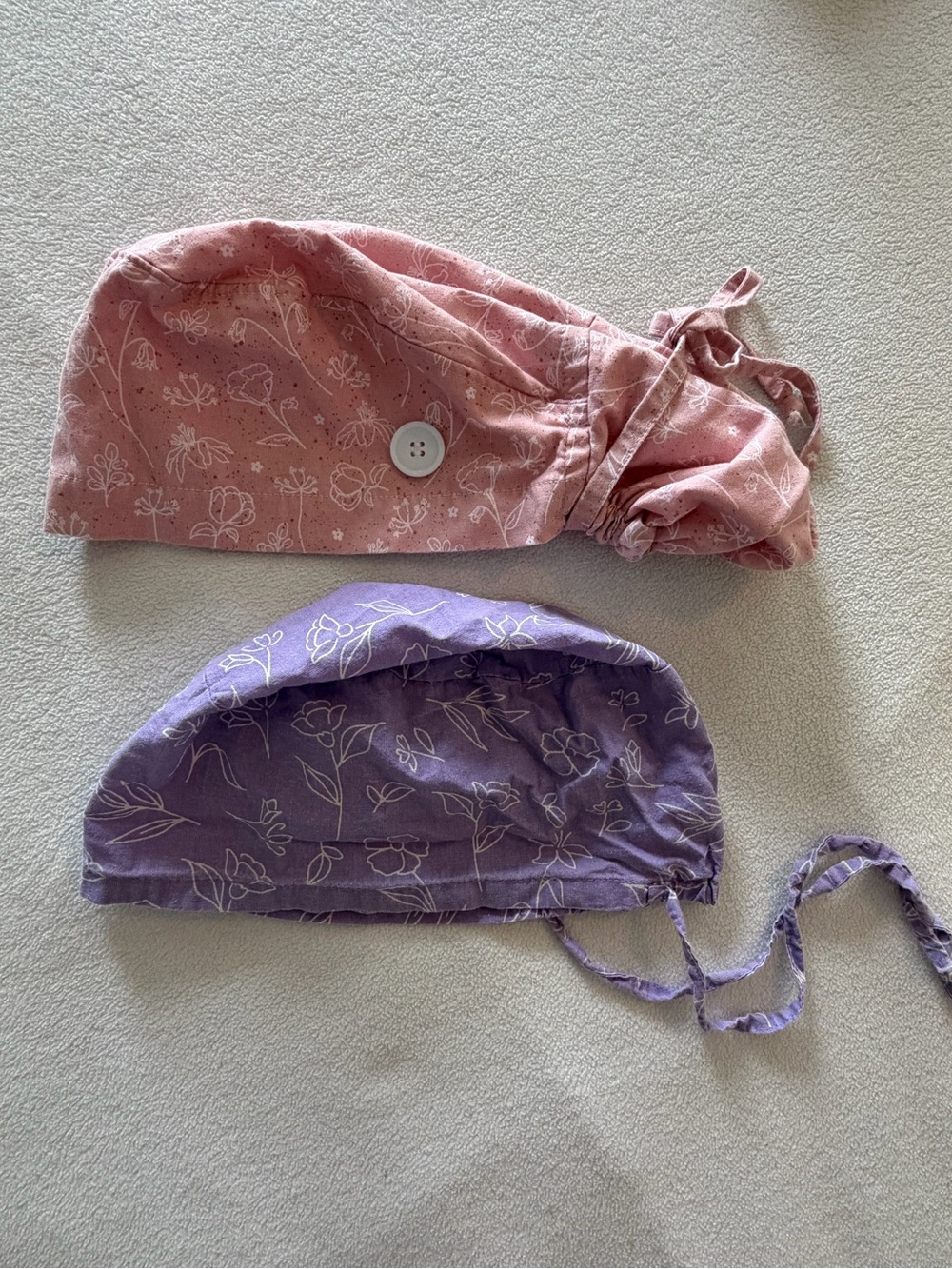 Pair of Floral Print Pink and Purple Scrub Caps with Button Detail